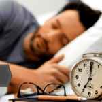 a man sleeping next to an alarm clock following the polyphasic sleep schedule
